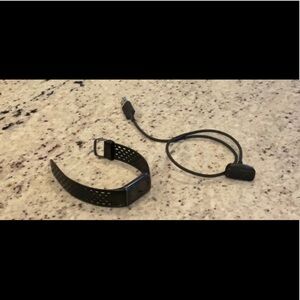 Fitbit charge 5 with charger.